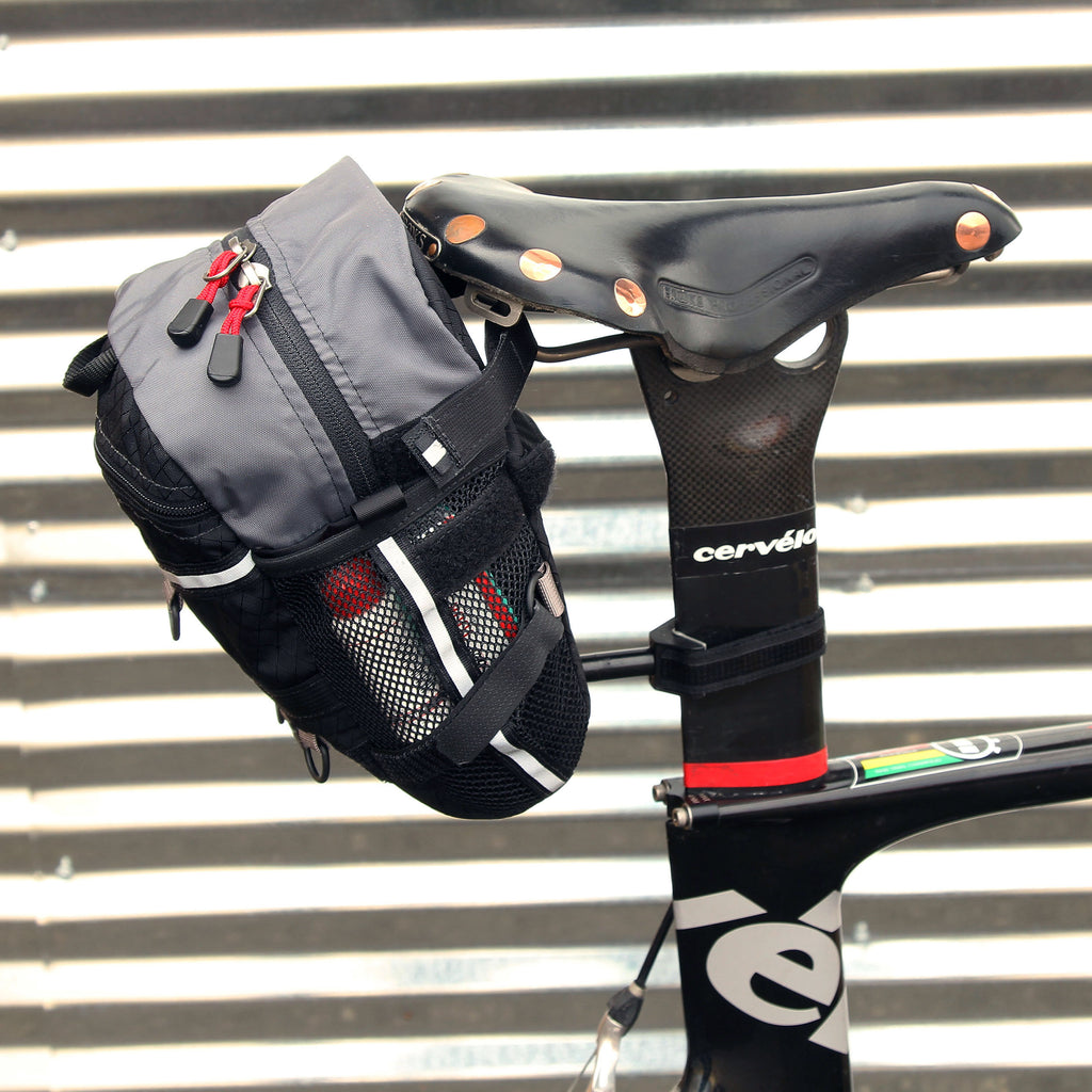This bag will also attach to most “aero” of seatposts, but may require us to make a custom extra-long strap.