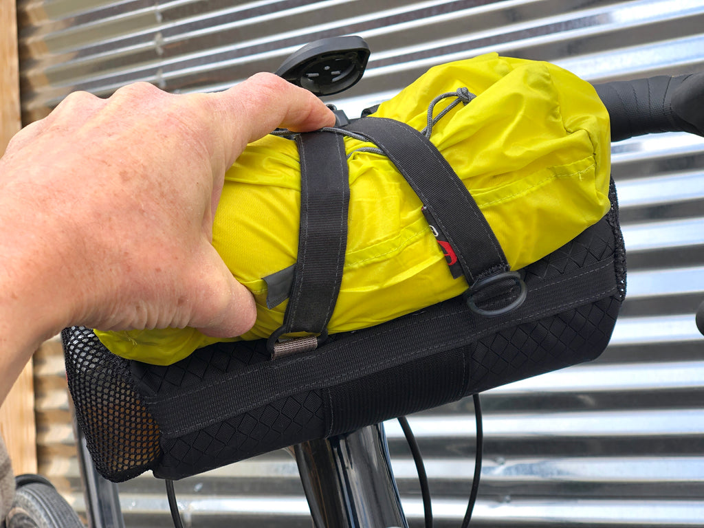 Single D-ring Strap ”A Mode” Instructions 2: Continue feeding the strap through the bottom left D-ring of the bag and back onto itself.