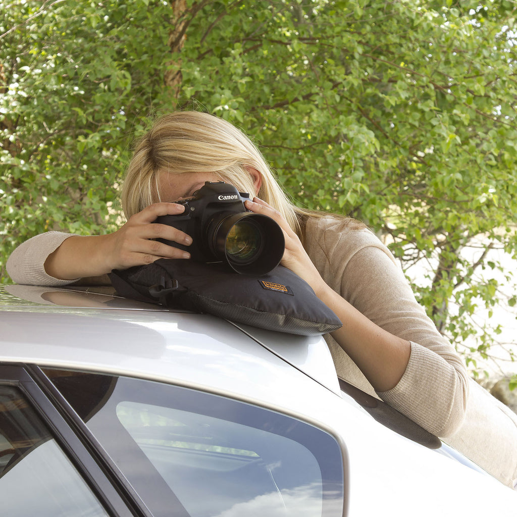 Shoot with it flat on top of a vehicle.