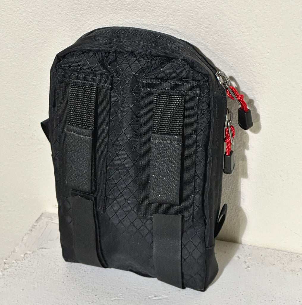 Back view showing the Dual Tab System or Kinesis Attachment Tab System. There are two additional Velcro strips on the bottom for stabilizing the bag when attached to a larger case.