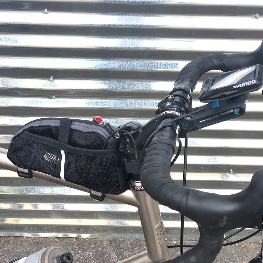Placing a small battery in the mesh side pocket enables powering of a GPS (or light) for longer rides (large size shown).