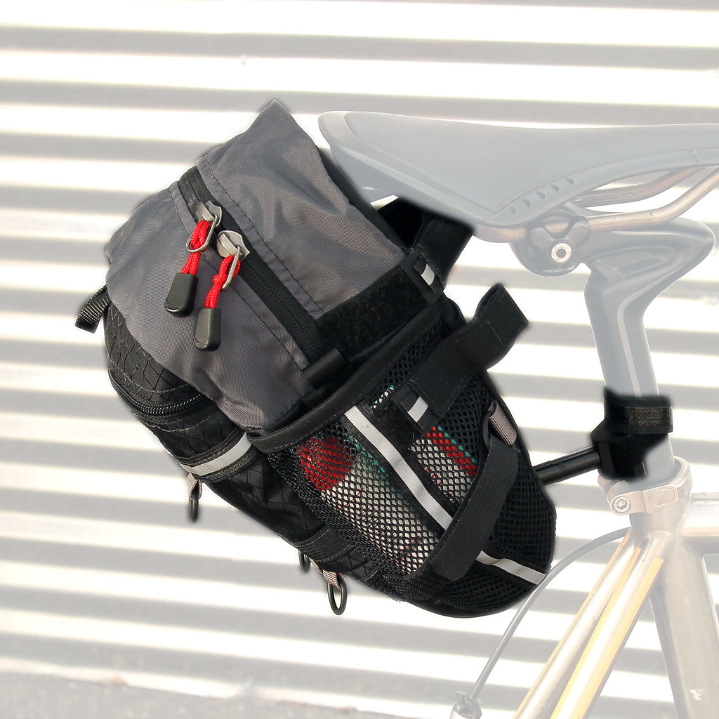 The bag attaches with two Velcro straps around the rails of the saddle and a third attachment point around the seatpost. Shown is the “upper” pair of straps which is preferred. The lower set is only for smaller frames.