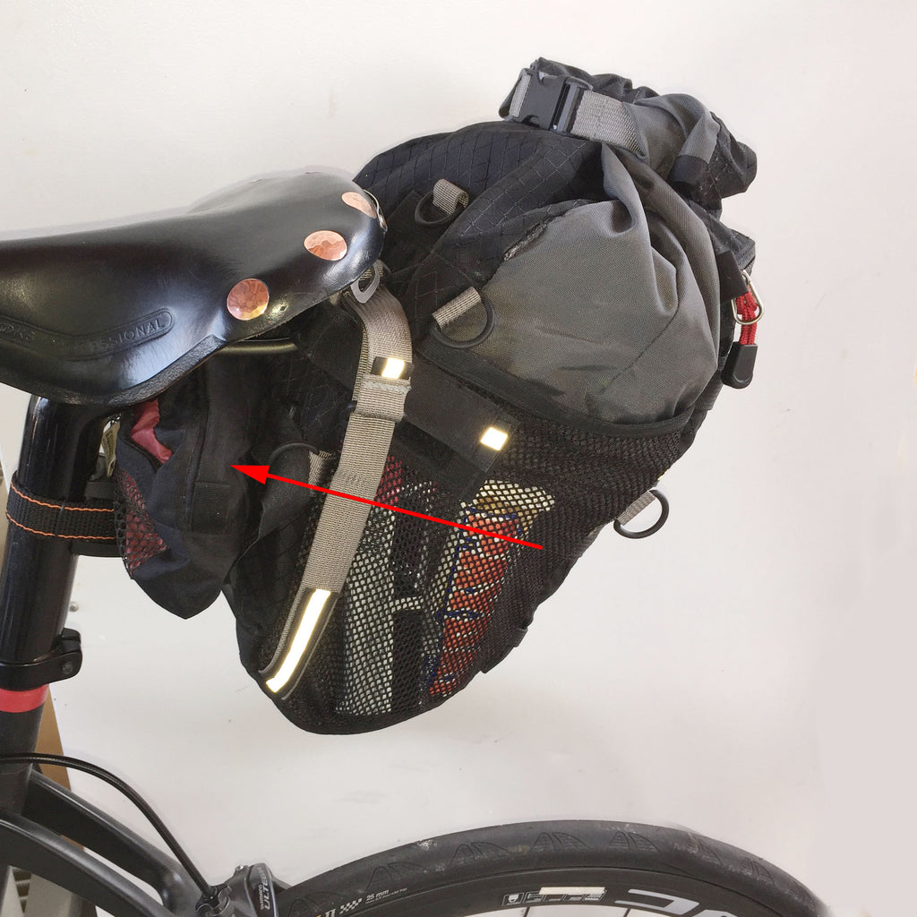The lightweight Equinox pouch can be attached forward of the bag, under the saddle (thighs may touch...not for everyone). Discontinued 9.0 bag shown.