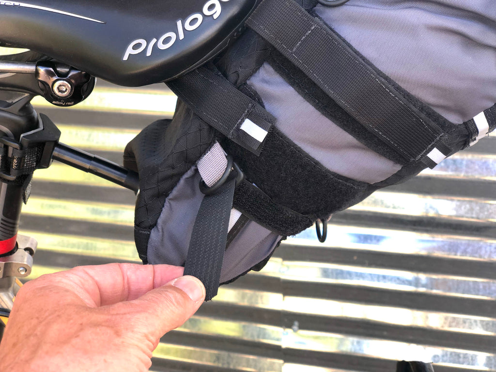 At the bottom of the bag is a pair of sewn-in compression straps, which minimize the size of the bag, providing more clearance. For use on smaller bicycle frames or bikes with fenders..
