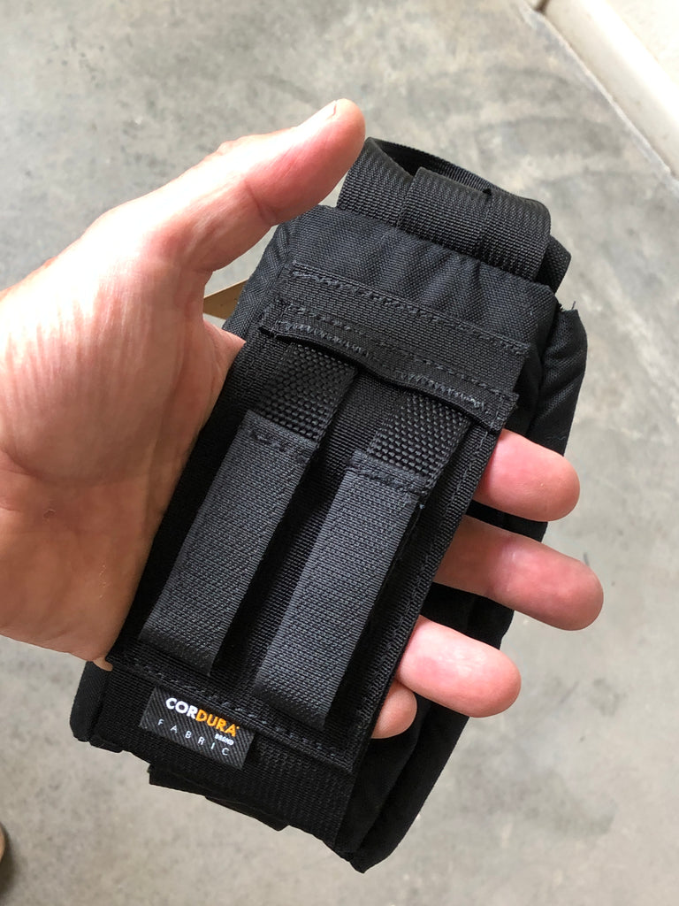 This pouch has a pair of KATS tabs (Velcro MOLLE-like tabs) for attaching to a Kinesis belt, but is also has an open sleeve behind it for slipping over a non-Kinesis backpack belt.