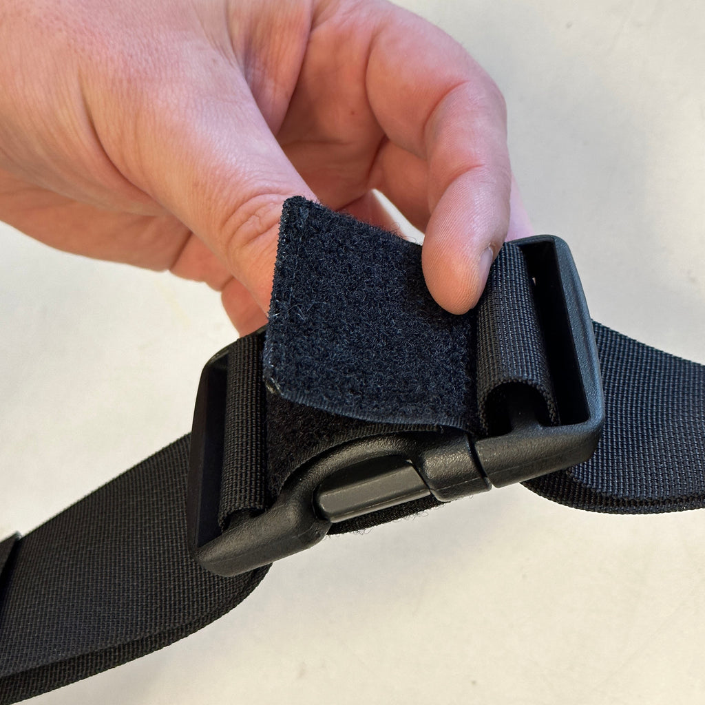 B516 is to prevent slash & grab of your belt while being worn. INSTRUCTIONS: after attaching the belt on yourself, slip the Velcro strap in between the buckle slots as shown and back onto itself. 