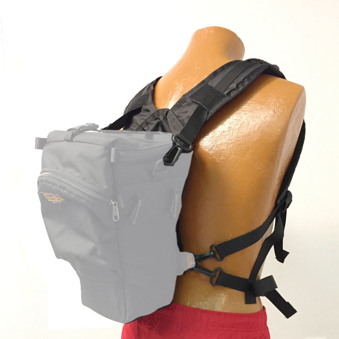 A holster case (not included) attached to a H344 harness. Attach the upper snap hooks from the harness to the side D-rings of the holster case is more stable than using the “back” holster D-rings.