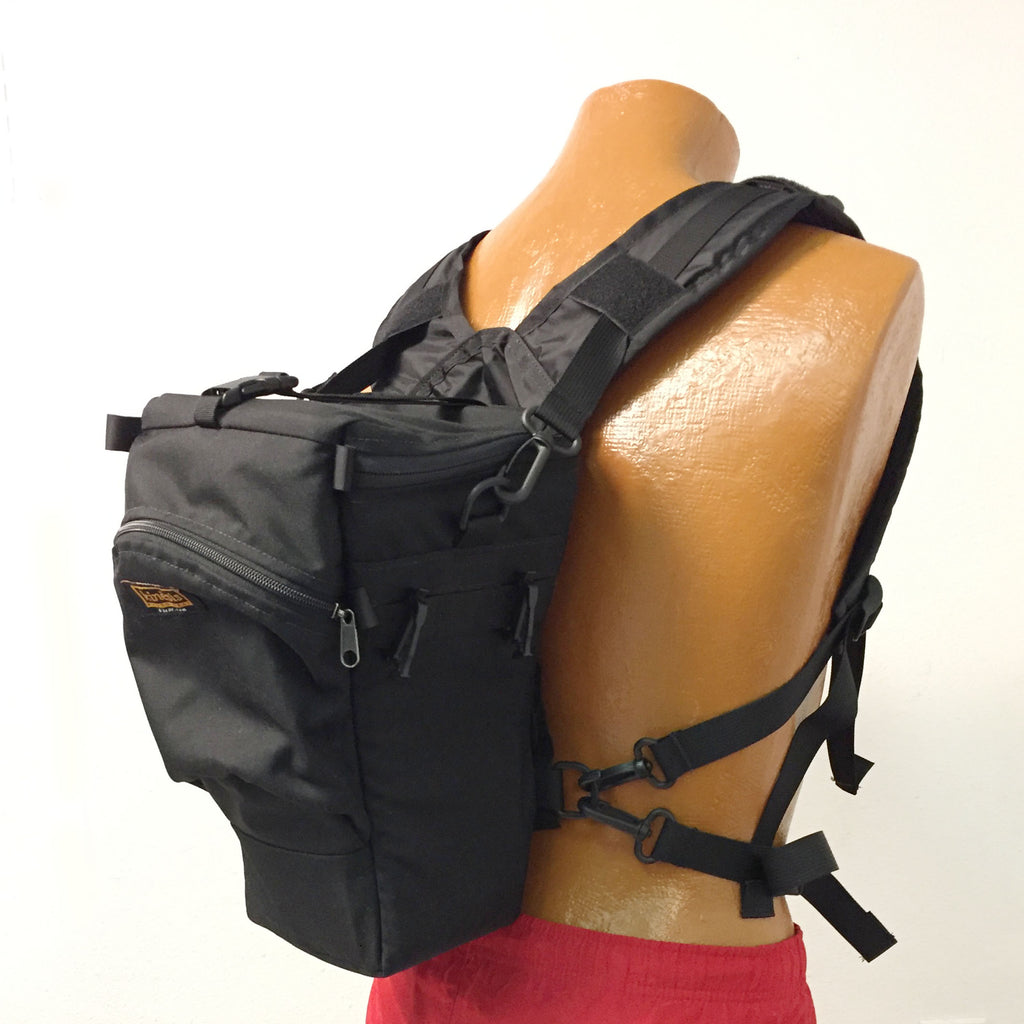 Note that the bottom straps of the harness and the torso strap clip to the bottom D-rings of the holster case. (The holster case is not included with the kit).