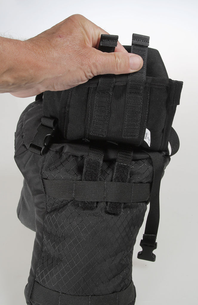 The Velcro tabs on the back of a pouch slide through the MOLLE-webbing for piggy-backing to the sack.