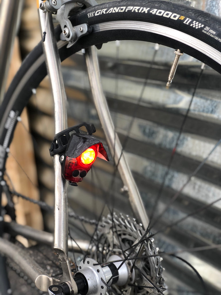 Example of the recommended location for  a tail light: attached to a seatstay, instead of on the seatpost or directly to a bag.